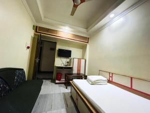 a small room with a bed and a tv at Hotel Haven in Agartala