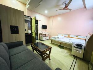 a living room with a couch and a bed at Hotel Haven in Agartala