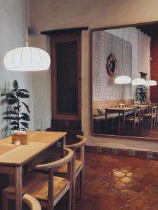 a dining room with a mirror and tables and chairs at Hotel Boutique Morada De Paz in Real de Catorce