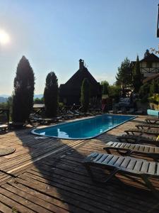 a swimming pool with lounge chairs and a house at 12 Місяців-Травень in Slavske