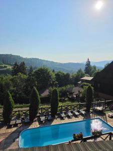 a view of a pool with lounge chairs at 12 Місяців-Травень in Slavske