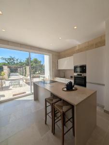 a kitchen with a large island with a counter top at NUX Rooms & Garden in Veglie