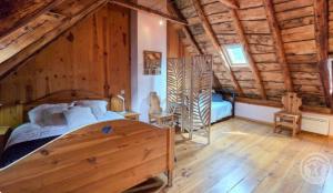 a bedroom with a bed in a wooden cabin at La Maison d'Aimée in Vielle-Aure
