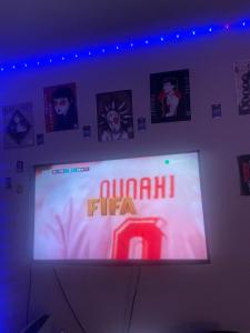 a large screen with a sign on a wall at Ann in London