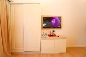 a room with a white cabinet and a tv at Guesthouse Micaj LUNI in Himare