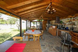 an outdoor kitchen with a table and chairs at Guesthouse Micaj LUNI in Himare
