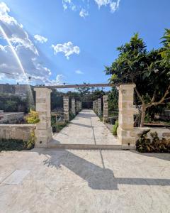 an entrance to a building with a stone archway at NUX Rooms & Garden in Veglie
