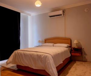 a bedroom with a bed with a white comforter at Golden Tree in Karaağaç