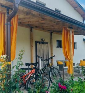 two bikes parked in front of a house at Guest house Villa Orlovo in Orlovo