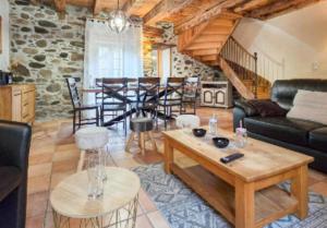 a living room with a couch and a table at La Maison d'Aimée in Vielle-Aure
