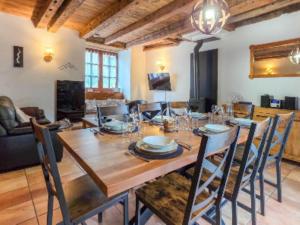 a dining room with a wooden table and chairs at La Maison d'Aimée in Vielle-Aure +14 photos