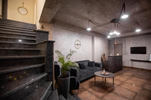 a living room with a couch and a table at AUTOGRAPH Kutaisi in Kutaisi
