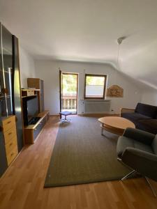 a living room with a couch and a table at Ferienwohnungen in Schönmünzach in Baiersbronn