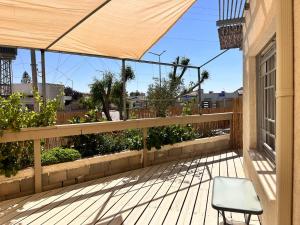 a patio with a chair and a fence at וילה אושר in Mitzpe Ramon