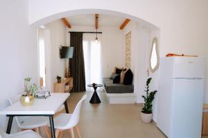 a white living room with a table and a couch at Enki's Heaven Premium Apartments in Glinádhon