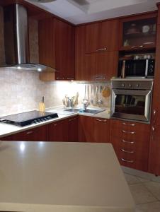 a kitchen with wooden cabinets and a stove top oven at appartamento in Bisceglie