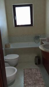 a bathroom with a toilet and a tub and a sink at appartamento in Bisceglie