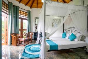 a bedroom with a bed with a canopy at Castle Colombo in Piliyandala