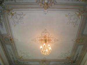 a chandelier hanging from a ceiling in a room at Résidence La Villa Léonie in Nice