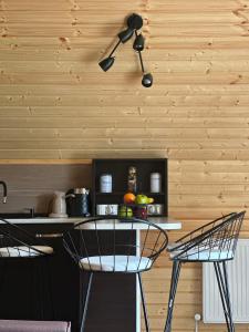 a kitchen with two chairs and a table at River Sound Chalet in Tba