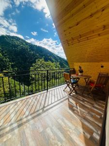 a balcony with a table and chairs and a view at River Sound Chalet in Tba