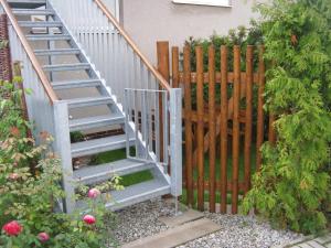 a staircase leading up to a house with a fence at Apartmán u Růženky in Veselí nad Lužnicí