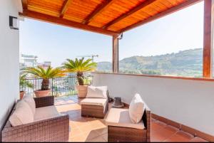 a patio with wicker furniture and a large window at Raggio Di Sole in Cosenza
