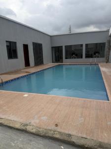 a large blue swimming pool in a building at Max Heights in Ikeja