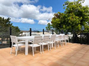 a white table and chairs on a patio at Spacious Private Villa up to 16 - Casa Quintero Yaiza - Volcano, Timanfaya park, Bodega & South Beaches - Heated Pool - Game Room - Charcoal grill in Yaiza