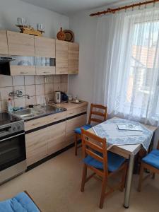 a kitchen with a table and chairs and a sink and a stove at Privat Veronika in Telč