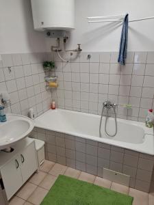 a bathroom with a bath tub and a sink at Privat Veronika in Telč