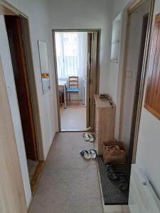 a hallway with a room with a door and some shoes at Privat Veronika in Telč