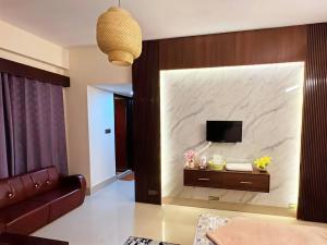 a living room with a large marble wall at Epindi Studio Apartment in Cox's Bazar