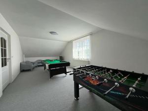 a room with a pool table in a room with a pool table at Rekreační chalupa Ivon in Hŭry