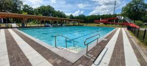 a large swimming pool with a slide in it at Mooi Drenthe in Wezuperbrug