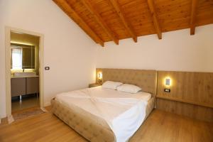 a bedroom with a bed with two pillows on it at Guesthouse Micaj LA KRIDEA in Himare +17 photos