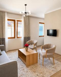 a living room with two chairs and a coffee table at 101 Apartments in Igalo +13 photos