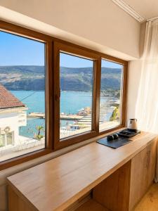 a room with a desk with two large windows at 101 Apartments in Igalo