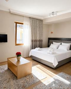 a bedroom with a large white bed and a window at 101 Apartments in Igalo