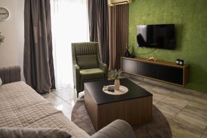 a living room with a couch and a tv at Apartments Kuc in Tivat