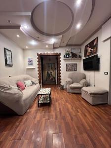 a living room with a couch and a tv at Kendaw home in Hihyā