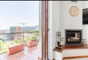 a living room with a fireplace and a balcony at Raggio Di Sole in Cosenza