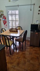 a kitchen with a table and chairs and a window at Arcoiris in General Acha