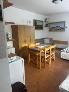a kitchen and dining room with a table and a couch at Slunečná Lada in Borová Lada