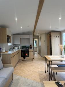 a kitchen and living room with a couch and a table at The Elms Escape in Porthcawl
