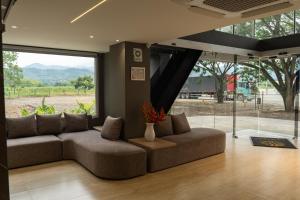 a living room with a couch and a large window at Hotel Caminos de Acapulco - Vía La Virginia Viterbo in Belalcázar