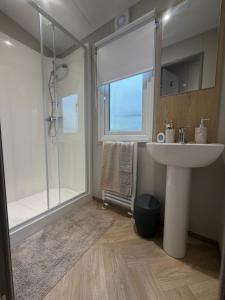 a bathroom with a sink and a shower at The Elms Escape in Porthcawl