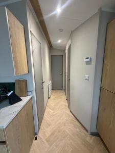 a hallway with a door leading into a room at The Elms Escape in Porthcawl +2 photos