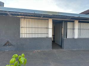 a building with barred windows and a door at Dormitório in Uberlândia