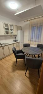 a room with a table and chairs in a kitchen at sakura-spa Jesenice in Rakovník